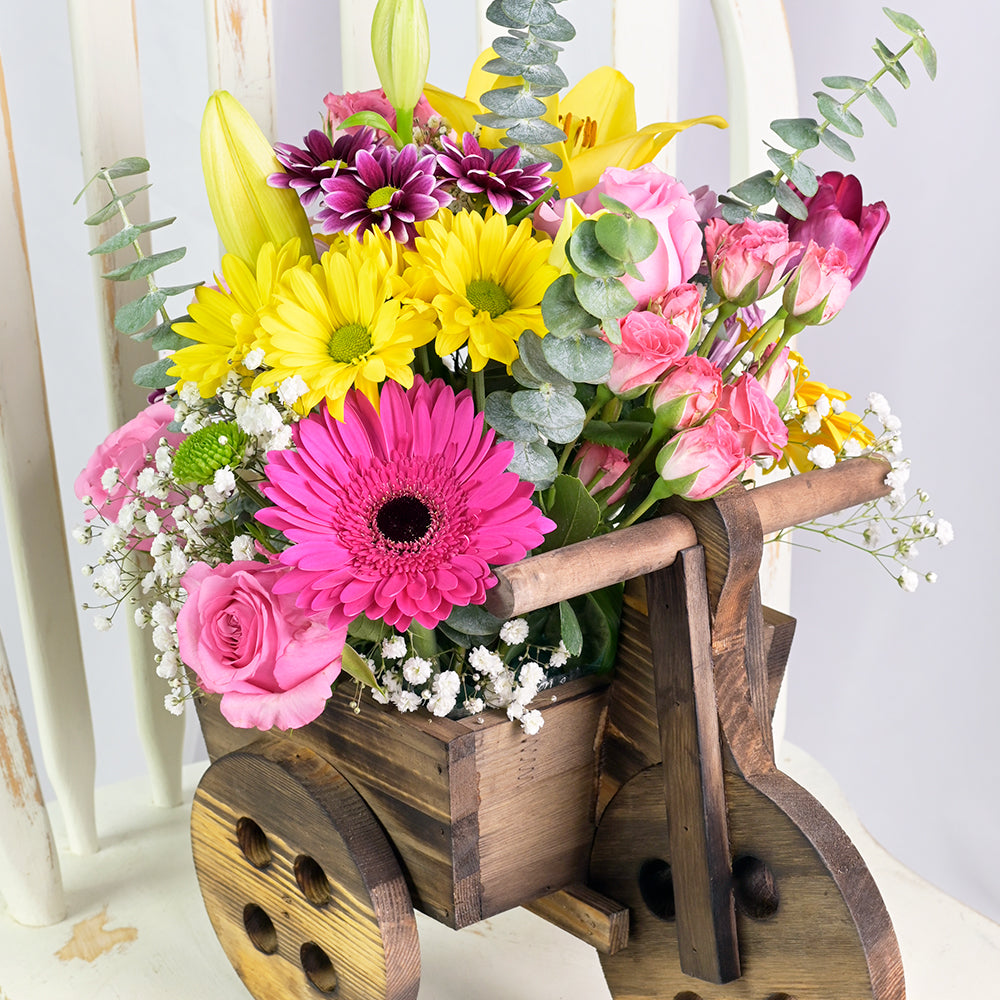 Wooden Cart Planter with Gerberas, Roses, and Lilies for Mother's Day – how the gift is presented