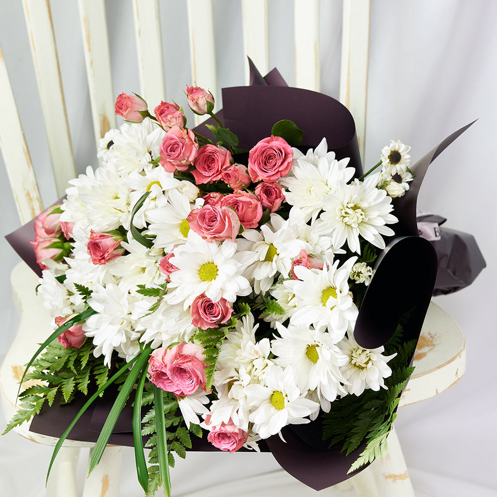 Tied Designer Ribbon Bouquet with White Daisies and Pink Spray Roses – how the gift is presented