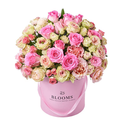 This large floral gift features pink and white roses gathered into a pink hat box for a wonderful way to breath of spring in any space.. Blooms America Delivery
