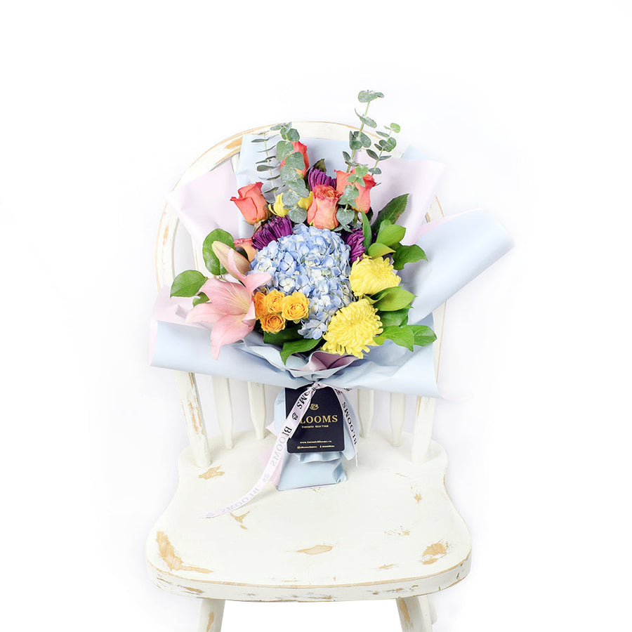 The Festive Purim Bouquet from America Blooms features a cheerful arrangement of roses, cremons and other flowers tied with a designer ribbon. America Blooms Delivery