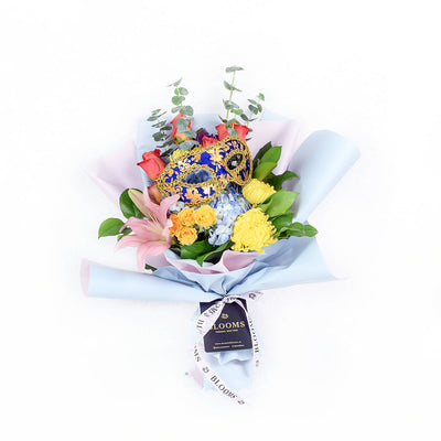 The Festive Purim Bouquet from Blooms America features a cheerful arrangement of roses, cremons and other flowers tied with a designer ribbon