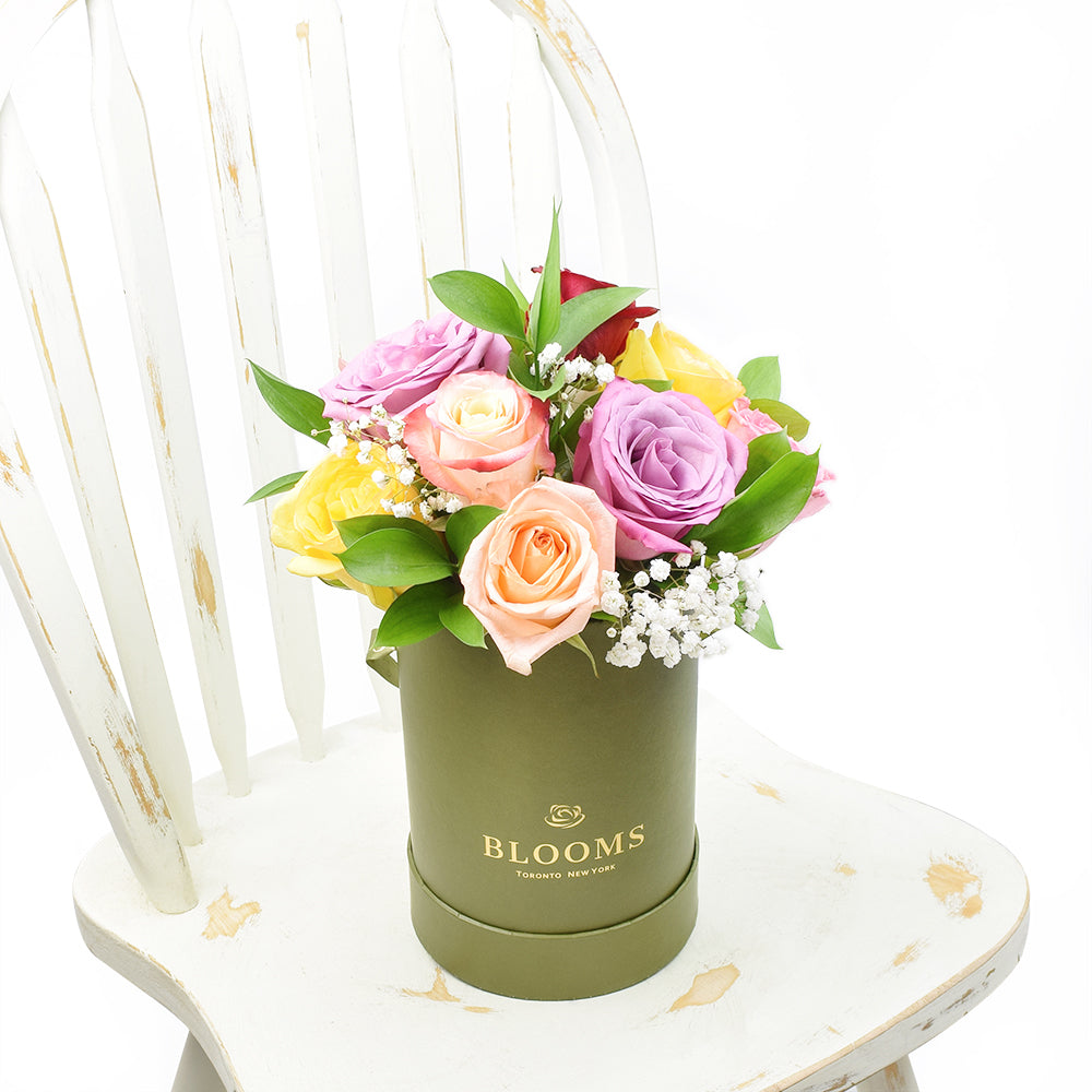 Vibrant Roses and Baby's Breath Floral Arrangement in Elegant Green Hat Box – how the gift is presented